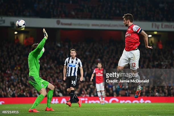 Olivier Giroud of Arsenal heads the ball past goalkeeper Tim Krul of Newcastle United to score their third goal during the Barclays Premier League...