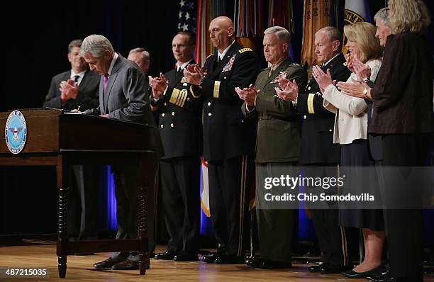 Defense Secretary Chuck Hagel signs the Department of Defense Human Goals Charter with Director of Administration and Management Michael Rhodes,...