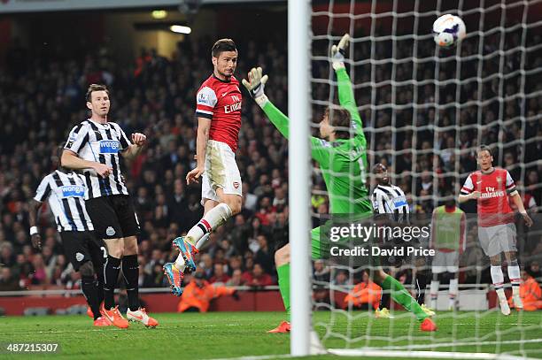 Olivier Giroud scores Arsenal's 3rd goal past Tim Krul of Newcastle as Mike Williamson of Newcastle looks on during the match between Arsenal and...