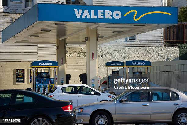 Vehicles drive past a Valero Energy Corp. Fueling station in San Francisco, California, U.S., on Friday, April 25, 2014. Valero Energy Corp. Is...