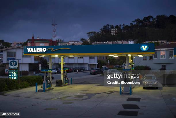 Woman fills her car with gasoline at a Valero Energy Corp. Fueling station in San Francisco, California, U.S., on Friday, April 25, 2014. Valero...