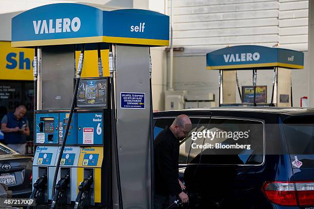 Man fills his car with gasoline at a Valero Energy Corp. Fueling station in San Francisco, California, U.S., on Friday, April 25, 2014. Valero Energy...