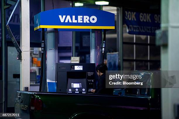 Man fills his truck with gasoline at a Valero Energy Corp. Fueling station in San Francisco, California, U.S., on Friday, April 25, 2014. Valero...