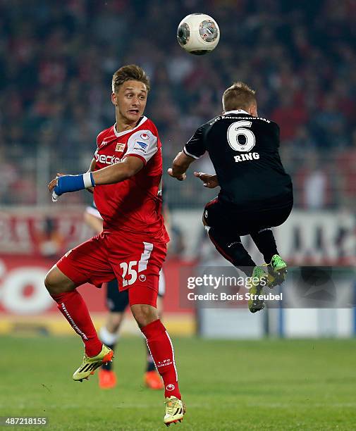 Alexander Ring of Kaiserslautern jumps for a header with Bjoern Jopek of Union Berlin during the Second Bundesliga match between 1.FC Union Berlin...