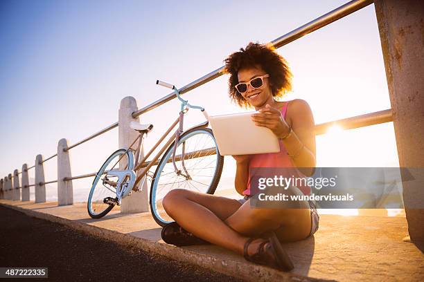 girl with digital tablet near beach - bike ipad stock pictures, royalty-free photos & images