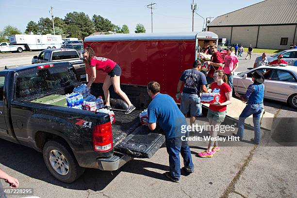 Volunteers load water at Beryl Baptist Church after a tornado yesterday tore through the area for the second time in three years, on April 28, 2014...