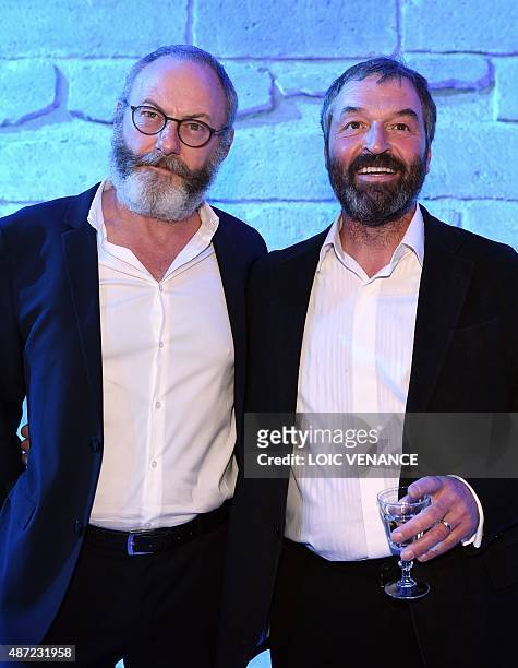 Irish actors Ian Beattie and Liam Cunningham pose on September 7, 2015 during the opening of an exhibition dedicated to HBO's television medieval...