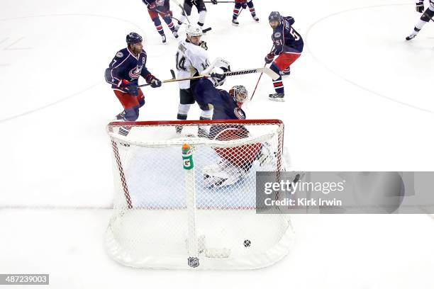 Chris Kunitz of the Pittsburgh Penguins watches as a shot from Evgeni Malkin of the Pittsburgh Penguins beats Sergei Bobrovsky of the Columbus Blue...