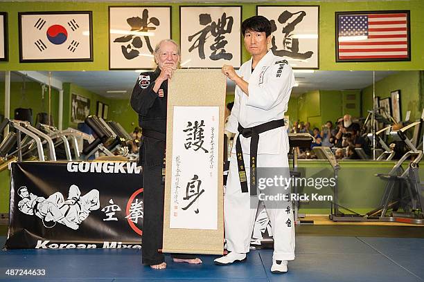 Musician Willie Nelson is presented with his 5th Degree Black Belt in the art of Gong Kwon Yu Sul by Grand Master Sam Um at his studio Master Martial...