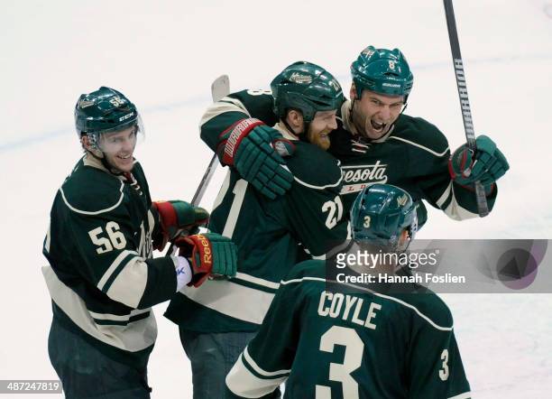 Erik Haula, Kyle Brodziak, Cody McCormick and Charlie Coyle of the Minnesota Wild celebrate a win against the Colorado Avalanche after Game Six of...