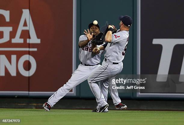Center fielder Michael Bourn makes a catch before nearly colliding with right fielder Ryan Raburn on an ball hit by Ian Stewart of the Los Angeles...