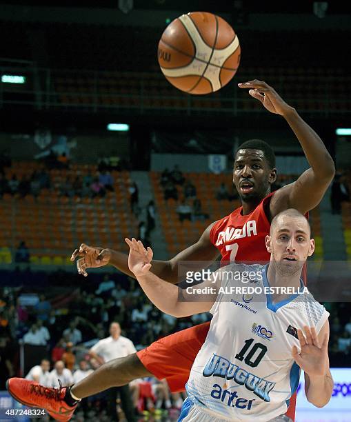 Canada´s power forward Andrew Nicholson vies for the ball with Uruguay´s small forward Marcel Souberbielle during their 2015 FIBA Americas...