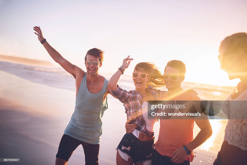 Happy teenage friends on beach