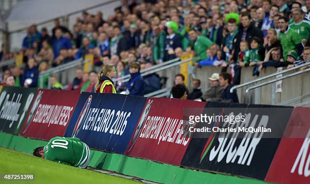 Kyle Lafferty of Northern Ireland lays injured during the Euro 2016 Group F qualifying match between Northern Ireland and Hungary at Windsor Park on...
