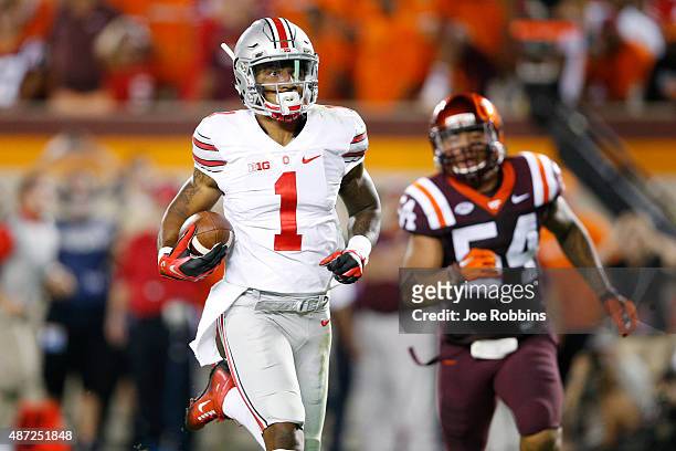 Braxton Miller of the Ohio State Buckeyes runs for a 53-yard touchdown in the third quarter against the Virginia Tech Hokies at Lane Stadium on...