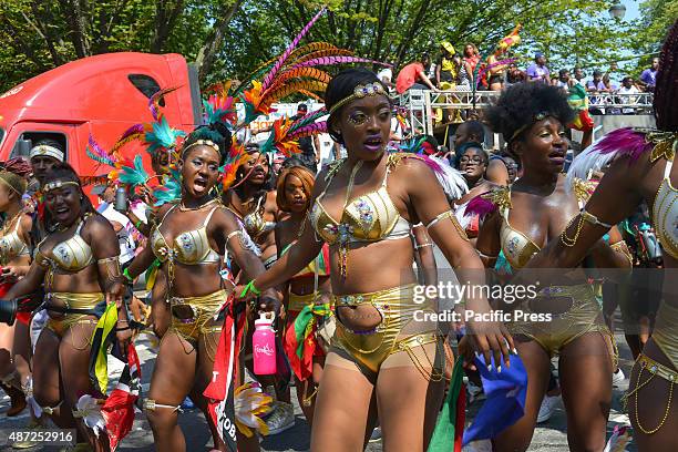 Troupe of dancers pose and make facial gestures to the crowd while marching in the parade. Massive crowds gathered along the Eastern Parkway in Crown...