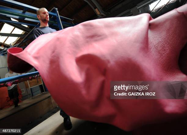 An employee manipulates skins to produce leather in the Remy Carriat tannery in Espelette, southwestern France, on April 10, 2014. Since 1927, the...