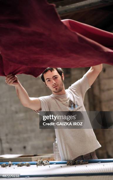 An employee manipulates skins to produce leather in the Remy Carriat tannery in Espelette, southwestern France, on April 10, 2014. Since 1927, the...