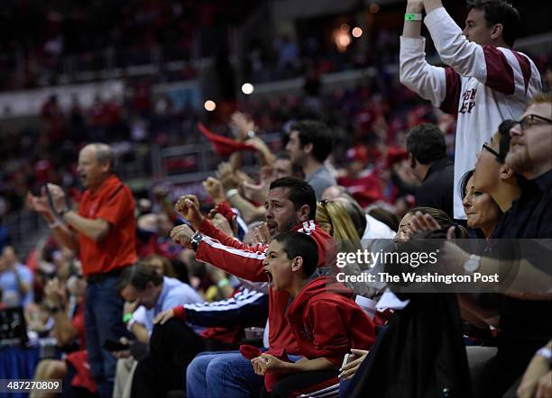 Fans celebrate an early Wizards lead in game four of the NBA play-offs between the Washington Wizards and the Chicago Bulls at the Verizon Center on...