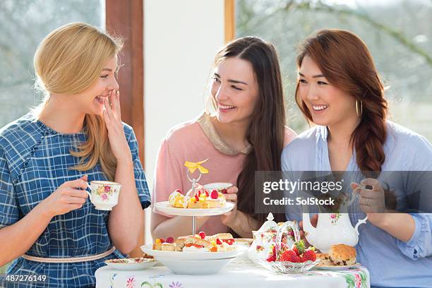 three friends having afternoon tea - tea time stockfoto's en -beelden