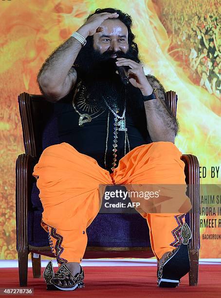 Indian chief of the religious sect Dera Sacha Sauda Gurmeet Ram Rahim Singh gestures during a news conference to launch the score for his forthcoming...