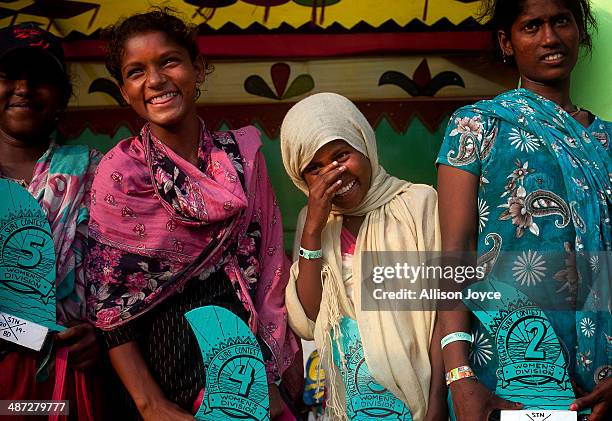 Year old Shuma and 10 year old Jahanara smile as they poses for photos with their awards during the annual Cox's Bazar surf competition April 24,...
