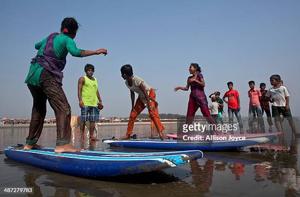 Rashed Alam teaches beach vendors to surf April 15, 2014 in Cox's Bazar, Bangladesh. A group of 10-12 year old female beach vendors, most of whom...
