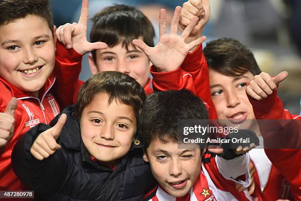 Child fans of Estudiantes pose for pictures during a match between Estudiantes and Aldosivi as part of 23rd round of Torneo Primera Division 2015 at...