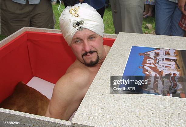 Czech fakir Zdenek Zahradka waves to his supporter while emerging from a wooden coffin after he survived 10 days buried underground without food and...