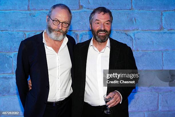 Irish actor Liam Cunningham and Ian Beattie pose during the opening of an exhibition dedicated to HBO's television medieval fantasy series "Game of...