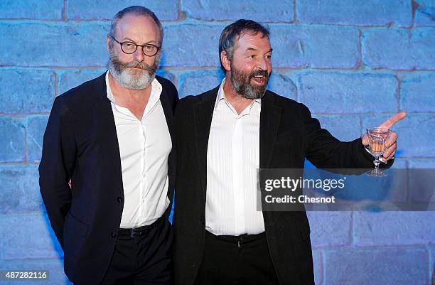 Irish actor Liam Cunningham and Ian Beattie pose during the opening of an exhibition dedicated to HBO's television medieval fantasy series "Game of...