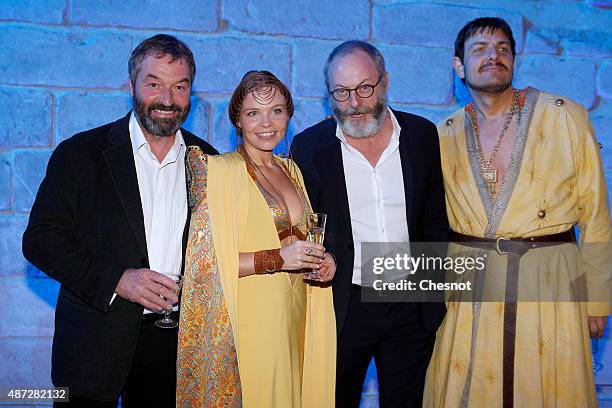 Irish actor Liam Cunningham and Ian Beattie pose with Games of Thrones cosplays during the opening of an exhibition dedicated to HBO's television...