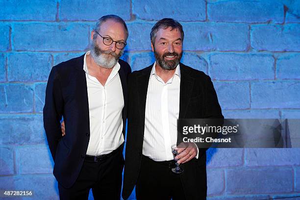 Irish actor Liam Cunningham and Ian Beattie pose during the opening of an exhibition dedicated to HBO's television medieval fantasy series "Game of...