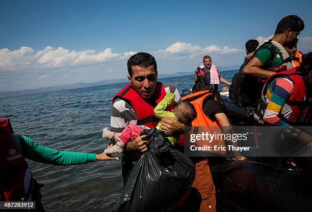 Refugees come ashore near the village of Skala Sikamineas on September 8, 2015 in Lesbos, Greece. More than 230,000 people have landed on Greek...