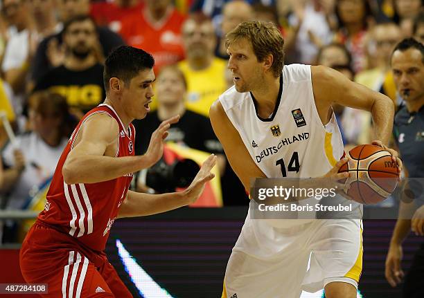 Dirk Nowitzki of Germany drives to the basket against Ersan Ilyasova of Turkey during the FIBA EuroBasket 2015 Group B basketball match between...