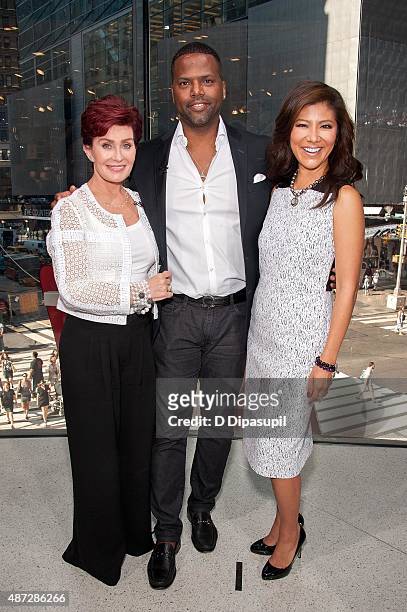 Sharon Osbourne, AJ Calloway, and Julie Chen pose on the set of "Extra" at their New York studios at H&M in Times Square on September 8, 2015 in New...