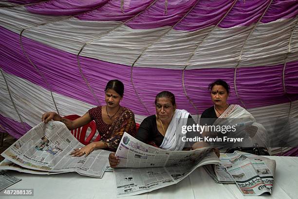 Transgender Candidate Hijra Guru Baseer Kinnar aka Kamala Kinnar, center , and disciples read newspapers after a press conference on April 21, 2014...