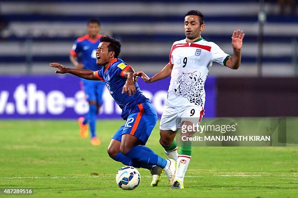 Iranian player Omid Ebrahimi vies for the ball with Indian player Lalpekhlua Jeje during the Asia Group D FIFA World Cup 2018 qualifying football...