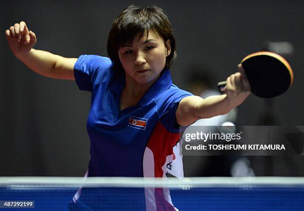 Kim Jong of North Korea returns the ball towards Natalia Partyka of Poland during their women's singles round three match of the 2014 World Team...