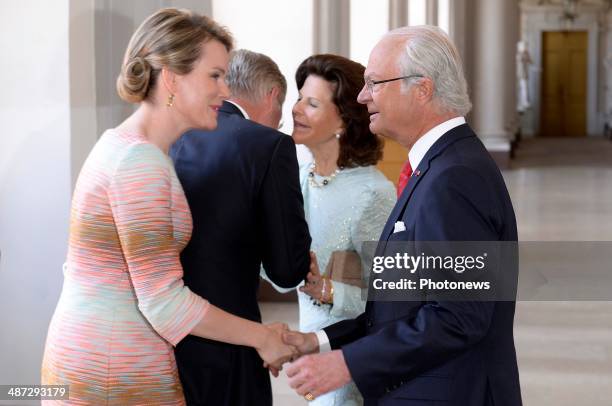 Official visit of Belgian Sovereigns to Sweden on April 29, 2014 in Stockholm, Sweden. Queen Mathilde and King Philippe pictured with King Carl...