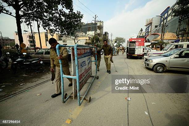Uttar Pradesh police barricading the road leading to Aam Aadmi Party office in Kaushambi after the attacked by Hindu Raksha Dal on January 8, 2014 in...