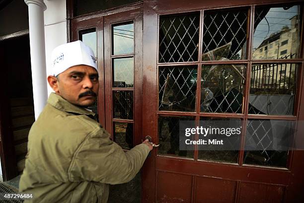 Member showing the damages at Aam Aadmi Party office in Kaushambi after it was attacked by Hindu Raksha Dal on January 8, 2014 in Ghaziabad, India....