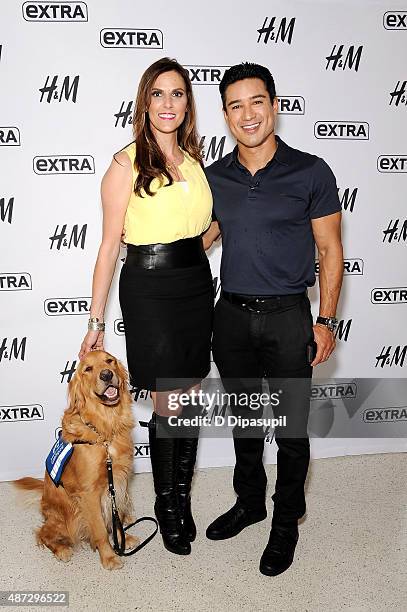 Taya Kyle and Mario Lopez pose on the set of "Extra" at their New York studios at H&M in Times Square on September 8, 2015 in New York City.