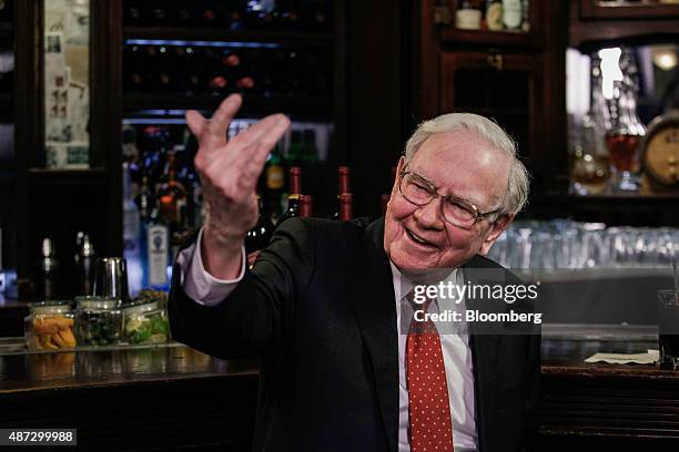 Warren Buffett, chairman and chief executive officer of Berkshire Hathaway Inc., speaks during a television interview at Smith & Wollensky restaurant...