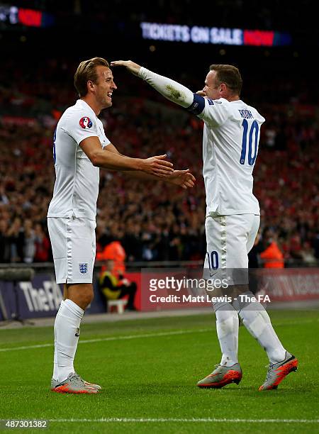 Harry Kane of England celebrates with teammate Wayne Rooney after scoring the opening goal during the UEFA EURO 2016 Qualifier Group E match between...