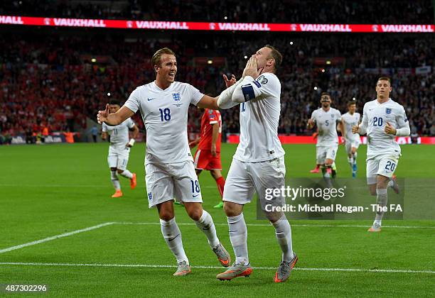 Wayne Rooney of England is congratulated by teammate Harry Kane after scoring his team's second goal breaking the record of 49 goals set by Sir Bobby...