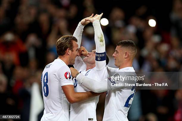 Wayne Rooney of England celebrates scoring his team's second goal breaking the record of 49 goals set by Sir Bobby Charlton with Harry Kane and Ross...