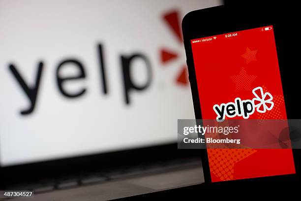 The Yelp Inc. Application and logo are displayed on an Apple Inc. IPhone 5s and iPad Air in this arranged photograph in Washington, D.C., U.S., on...