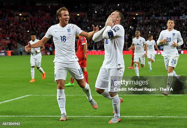 Wayne Rooney of England celebrates scoring his team's second goal breaking the record of 49 goals set by Sir Bobby Charlton with Harry Kane during...