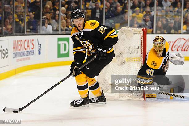 Kevan Miller of the Boston Bruins skates with the puck against the Detroit Red Wings in Game Five of the First Round of the 2014 Stanley Cup Playoffs...